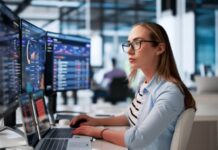 Cybersecurity Risk Management: A Practical Framework Using NIST CSF 2.0 Cybersecurity risk management professional monitoring security dashboards